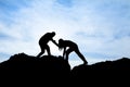 Silhouette of helping hand between two climber Royalty Free Stock Photo